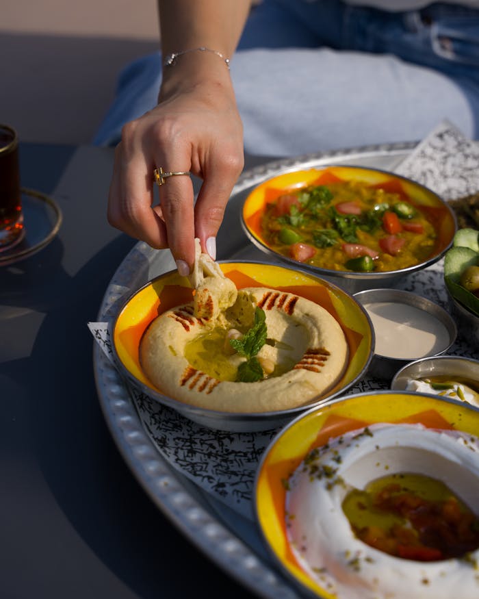 A delicious spread of hummus and falafel on a vibrant plate, perfect for a cultural feast.