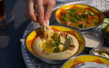 A delicious spread of hummus and falafel on a vibrant plate, perfect for a cultural feast.